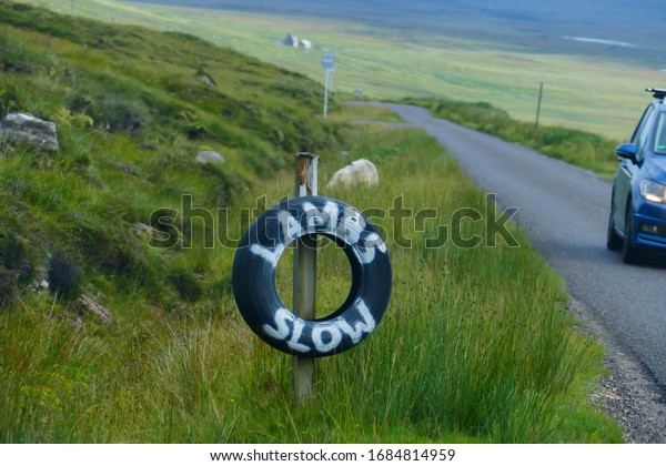 Reference to wheel, with the English words,\
lambs slow in the Highlands of Scotland\

