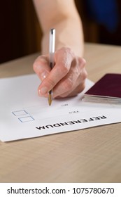Referendum ballot paper, black pen, and passport on the table. Closeup - Shutterstock ID 1075780670