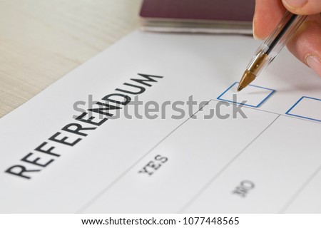 Referendum ballot paper, black pen, and passport on the table. Closeup