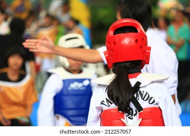 Referree Gives Signal To Girls During Taekwondo Fighting Contest