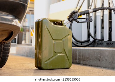 Refilling canister with fuel on the petrol station. Close up view. Fuel, gasoline, diesel is getting more expensive. Petrol industry and service. Petrol price and oil crisis concept.