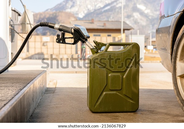Refilling\
canister with fuel on the petrol station. Close up view. Fuel,\
gasoline, diesel is getting more expensive. Petrol industry and\
service. Petrol price and oil crisis\
concept.