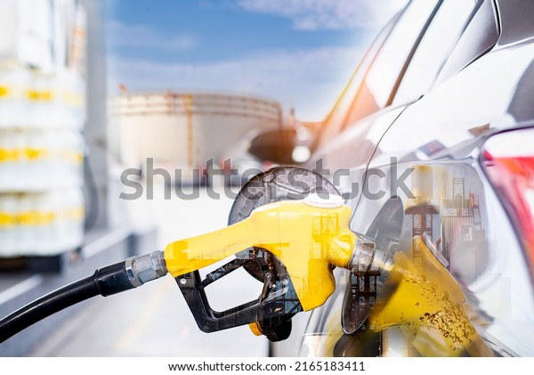 Refilling the\
car with fuel at the gas station and blurry staff background,\
refilling the car with fuel at the refuel station, the concept of\
fuel energy, Blurry image for\
background.