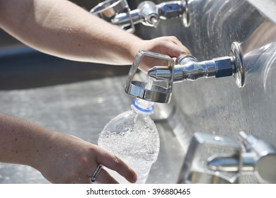 Refilling A Plastic Water Bottle From A Tap