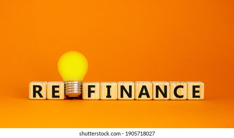 Refinance symbol. Wooden cubes with word 'refinance'. Yellow light bulb. Beautiful orange background. Business and refinance concept. Copy space. - Shutterstock ID 1905718027