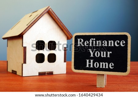 Refinance Your Home mortgage board and wooden house.