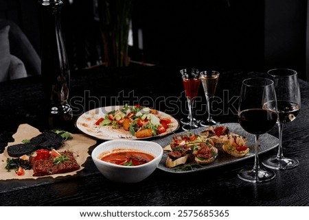 Refined Dining Table with Appetizers, Soup, and Wine.