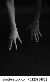 Refined and elegant hands of a dancer, dancing with body parts, black and white portrait of the performer's hands on a dark background - Shutterstock ID 2125954832