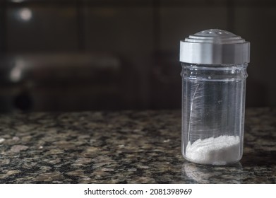 Refined Salt In A Salt Shaker And Dark Background, Copy Space Left