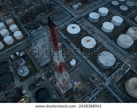 Refineries and the three steam crackers in the port of Antwerp, Belgium at dusk. Petrochemical silos and storage containers. Chemical production, oil and chemical production. Aerial drone view.