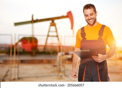 Refinery Worker Reads The Data From The Black Plates, The Background To The Oil Pump