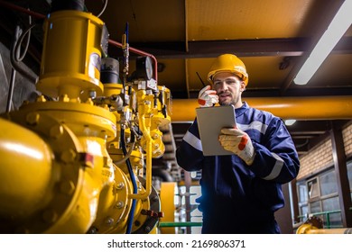 Refinery worker supervisor checking natural gas consumption and pipeline installations in petrochemical industry.