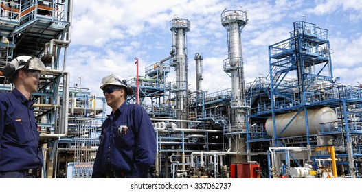 refinery workers inside large oil and gas petrochemical refinery