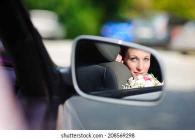 reflected in the car mirror bride