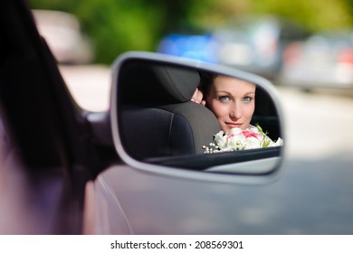 reflected in the car mirror bride