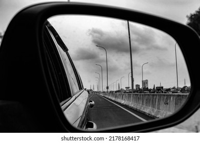 Reflected Road In Rearview Mirror