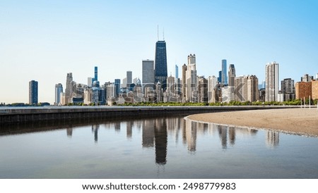 the reflected skyline of chicago in the early morning light