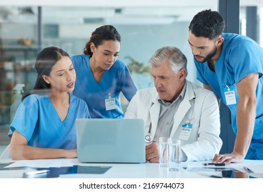 Reflecting On The Positive Changes. Shot Of A Group Of Nurses Having A Meeting With Their Head Doctor.