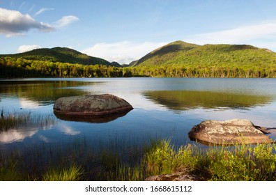 Reflection of adirondack mountains in summer lake