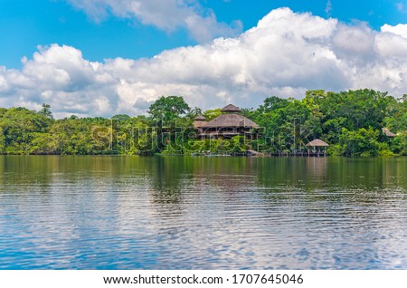 Reflection of an Amazon Rainforest Lodge. The Amazon Region comprise the countries of Suriname, Guyana, French Guyana, Venezuela, Colombia, Ecuador, Peru, Bolivia and Brazil.