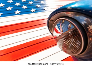 Reflection of American flag in the headlight of a classic car on route 66 america's iconic highway - Shutterstock ID 1369422518