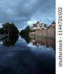 Reflection of blue sky and clouds in a huge puddle