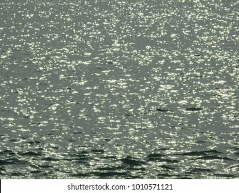 Reflection of blurred rays of the sun in water