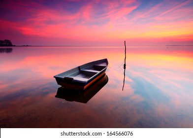 Reflection of Boat During Sunrise