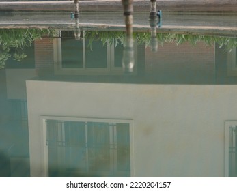 The reflection of a building in a pool. 