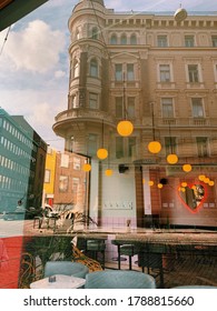 Reflection Of The Building In The Window Of The Coffee Shop, Busy Street In Helsinki, Finland. Mix Of The Urban Style And Historical Architecture