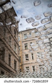 Reflection of buildings in a puddle