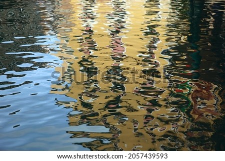 Reflection of buildings in the waters of Venice. Vivid colors of water in Vinice 