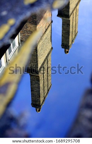 A reflection of Cambridge chimneys