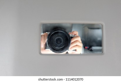 Reflection Camera lens with hand in mirror  