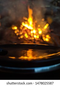 a reflection of a camp fire