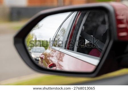 Reflection in a car wing mirror 