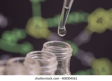 Reflection of chemical formula in water drop on test tube in front of blur chemical formula