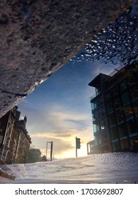 Reflection of the city in a puddle.
