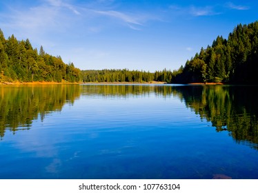 Reflection In Clear Blue Lake In Northern California