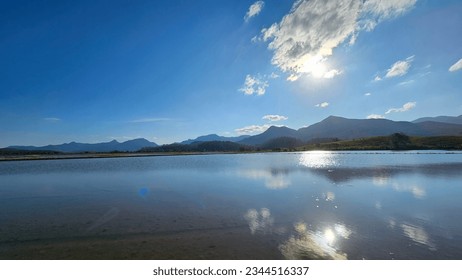 reflection of clouds on the water of irrigated rice fields in the late afternoon.