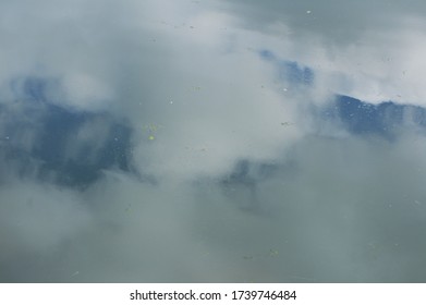 the reflection of clouds in the water