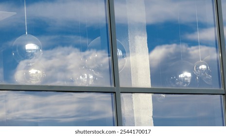 The reflection of the clouds in the window is very clear and bright. The light from the sun is shining through the glass, creating a beautiful and serene atmosphere