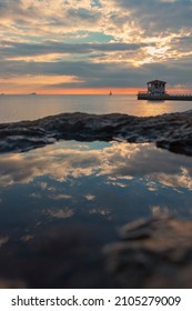 Reflection of cloudysky on the surface water. The historical pier in the Moda district of Kadikoy on Istanbul's Asian shore.Copy paste, text space. Vertical banner. Empty space for text. - Shutterstock ID 2105279009