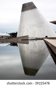 Reflection of conical shaped building in a pool of calm water