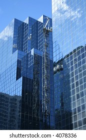 reflection of construction crane in windows