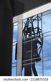 Reflection of cranes built by stothert and pitt limited in the windows of a building on millwall outer dock 