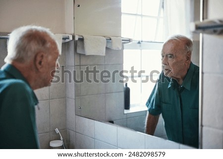 Reflection, elderly man and thinking in bathroom for retirement, healthcare and wellness. Remember, mirror and male person with Alzheimers, mental health and home for memory problem in apartment