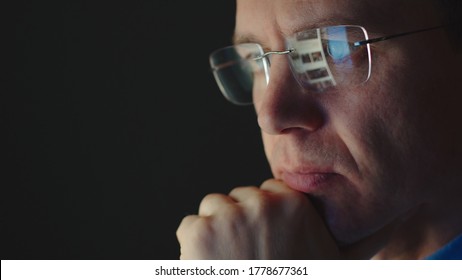 REFLECTION: Face Of Adult Businessman In An Eyeglasses Looking A Website