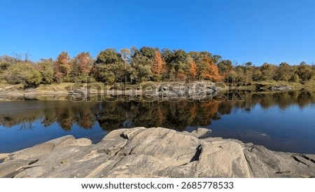 Reflection of fall foliage on the St Francois River 