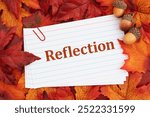 Reflection with fall leaves on reminder index card on wood for self-reflection